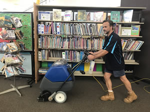 Cleaning carpet in school library